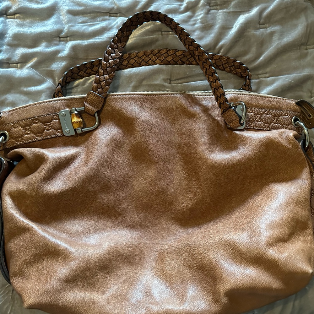 Caramel coloured brown leather Gucci bag with braided straps and silver detail.